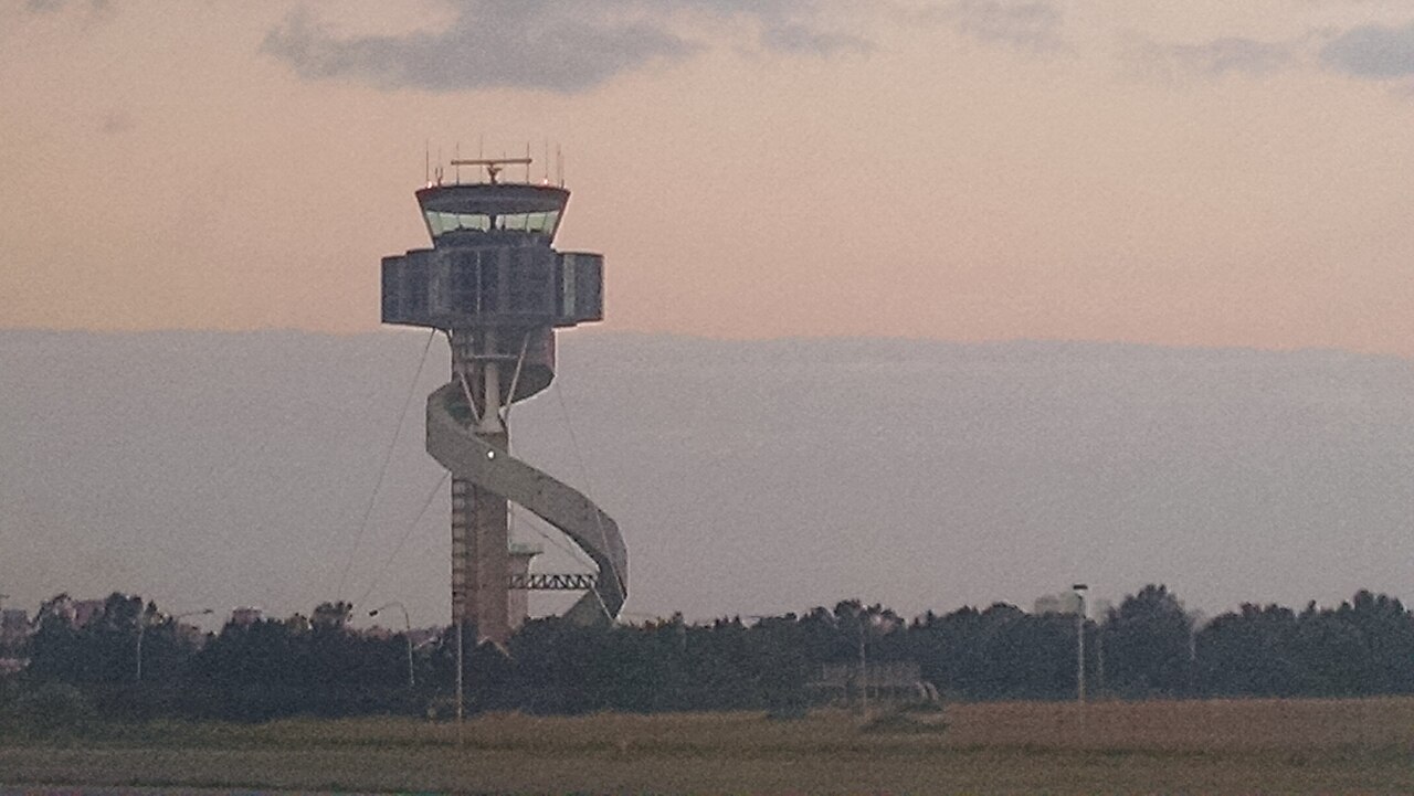 The air traffic control tower at Sydney Airport at dusk, photographed from an aircraft