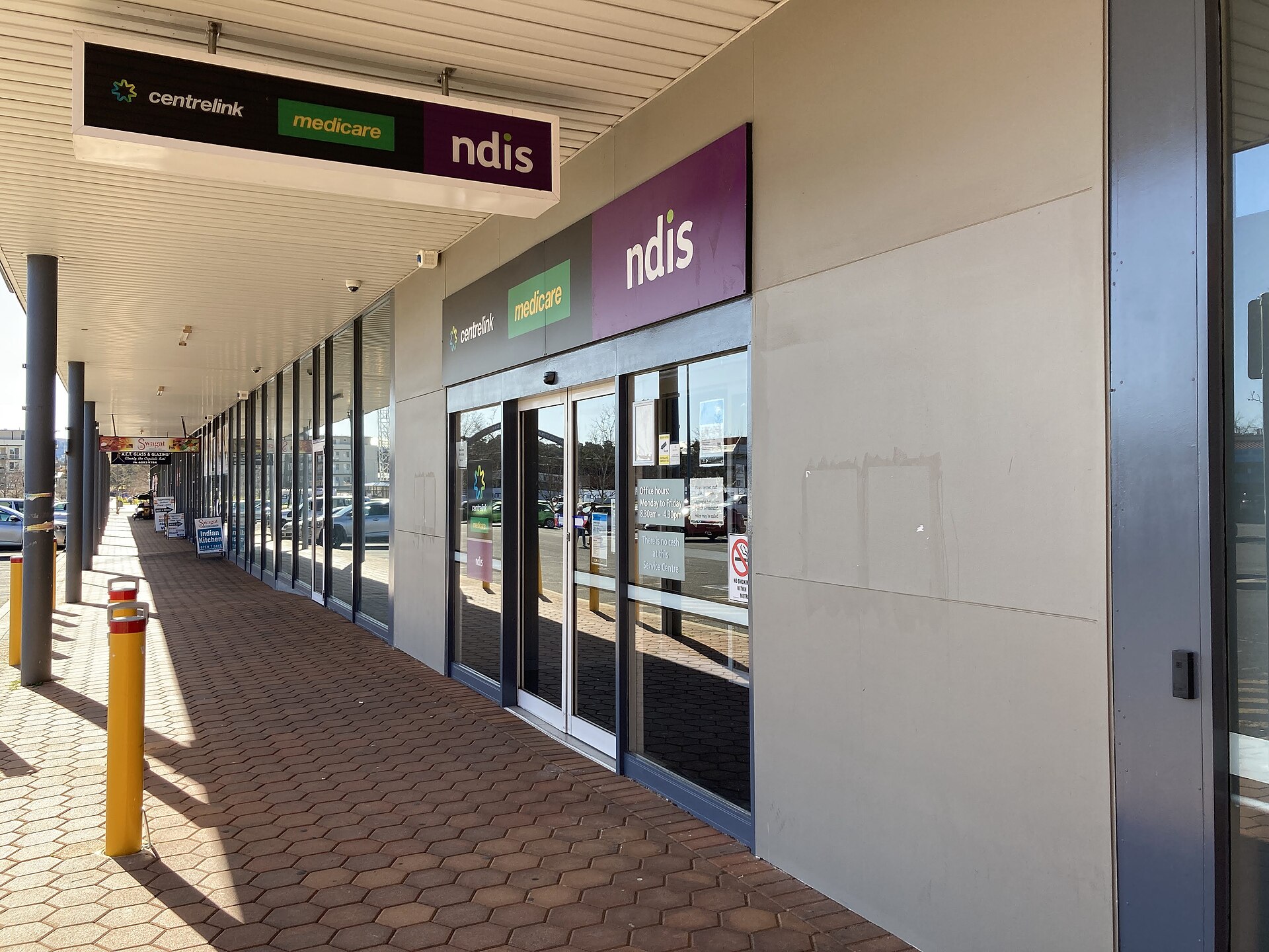 Entrance to a Services Australia service centre with Centrelink, Medicare and NDIS signage